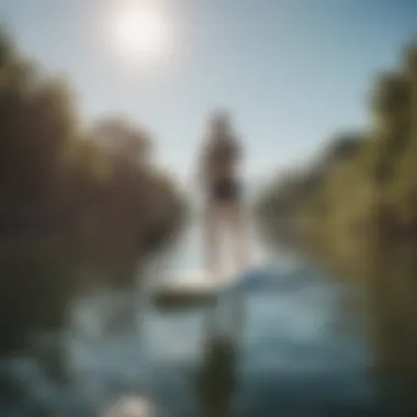 A beginner paddle boarder practicing balance on a sunny day