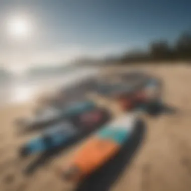 An array of kitesurfing boards arranged on a beach, highlighting different designs and features.