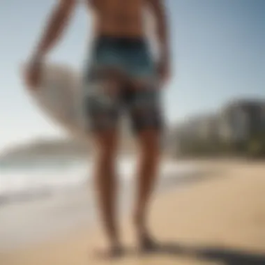 Side view of a surfer wearing Billabong custom boardshorts on the beach.