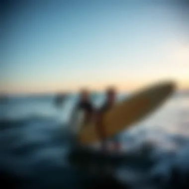 A breathtaking view of surfers riding the waves at sunset