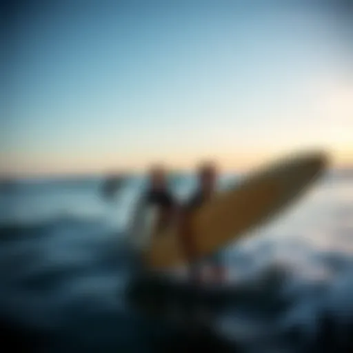 A breathtaking view of surfers riding the waves at sunset