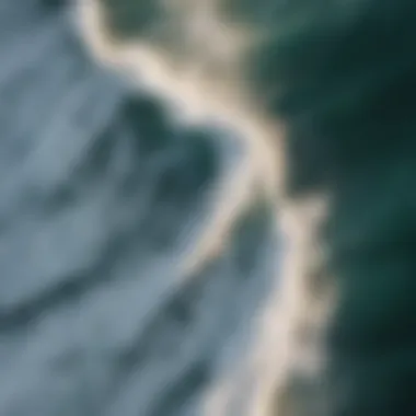 An aerial view of waves breaking on the shore, illustrating the beauty of ocean waves.