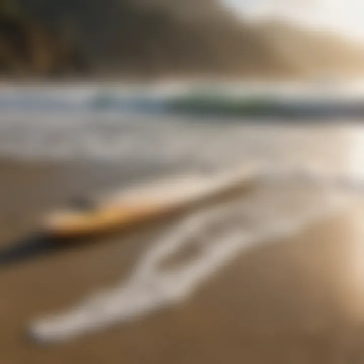 Surfboard resting on the sandy shore with waves in the background