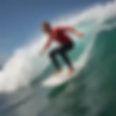 Surfboard with FCS Kolohe Andino fins in action on a wave