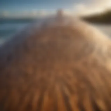 Close-up of a surfboard with cultural carvings reflecting local traditions