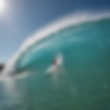 Surfers riding waves at a Kelly Slater wave pool under clear blue skies