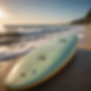 Odysea Board at the Beach A vibrant Odysea foam surfboard on the beach with waves in the background.