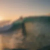 Surfer riding a wave at sunset